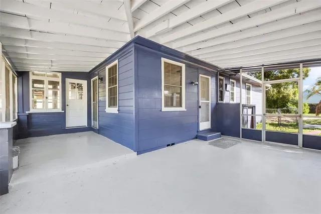 a view of an empty room with a fireplace and a window