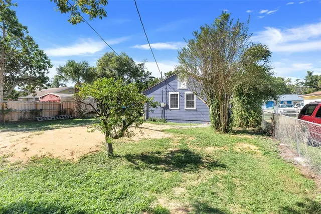 a view of a backyard with large tree