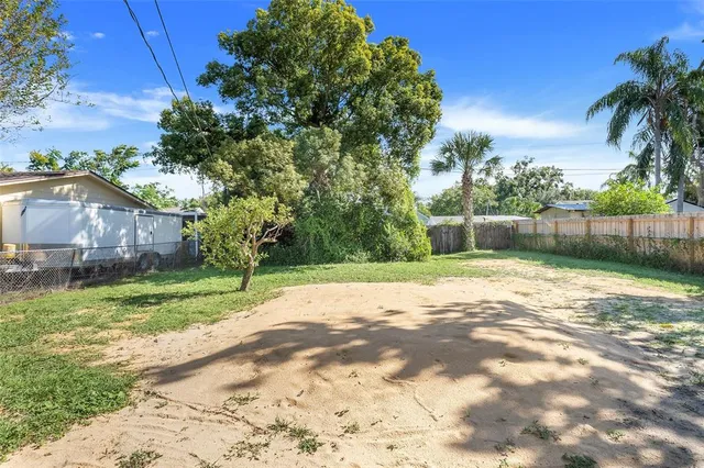 a view of a yard with a house in the background