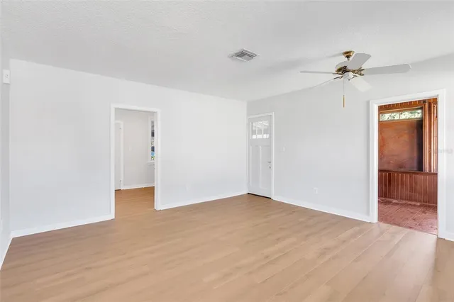 a view of an empty room with a ceiling fan