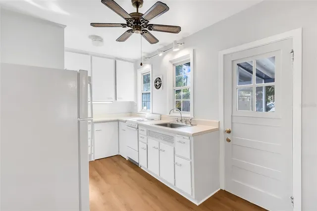 a kitchen with a sink appliances and cabinets