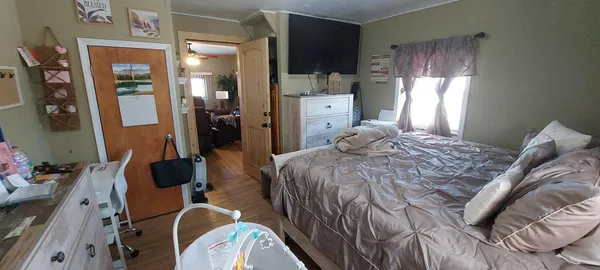 a bedroom with a bed closet and a large mirror