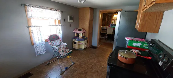 a kitchen with stainless steel appliances granite countertop a sink a stove and a wooden cabinets