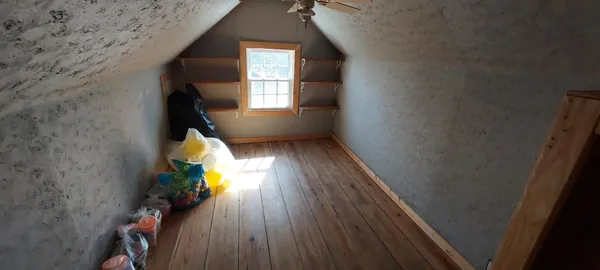 a view of a hallway with entryway wooden floor and front door