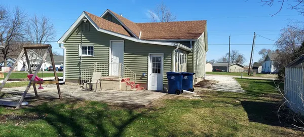 a view of a house with backyard and sitting area