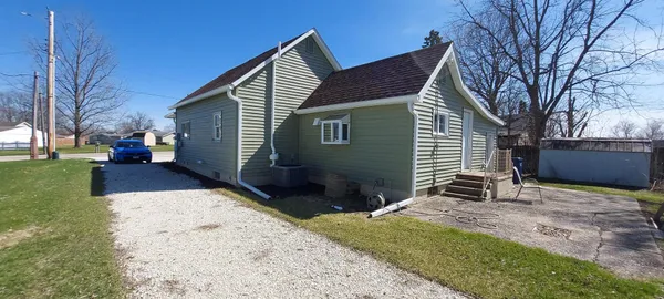 a backyard of a house with yard and outdoor seating