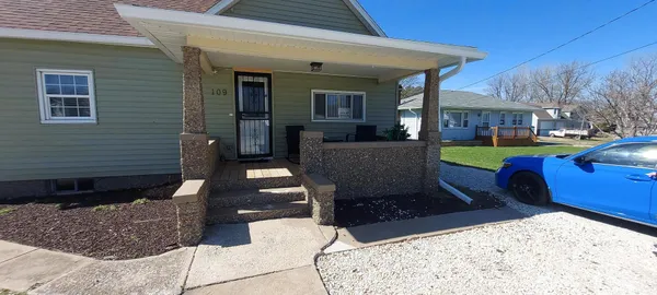 a view of a porch with furniture and a fire pit