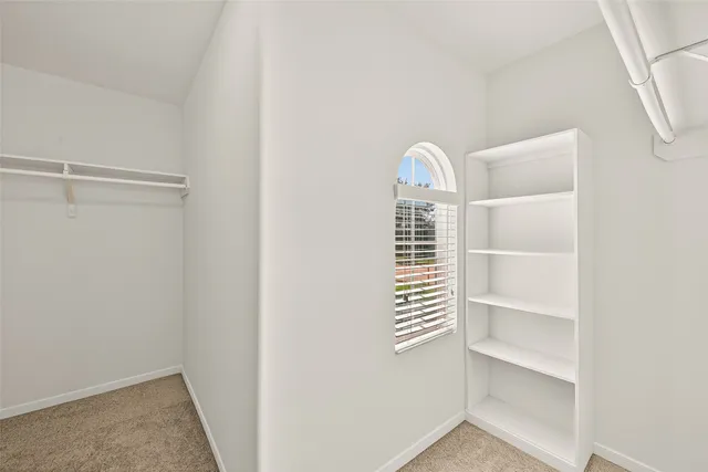 a view of closet area with empty racks