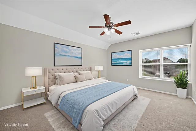 a bedroom with a large bed and a window