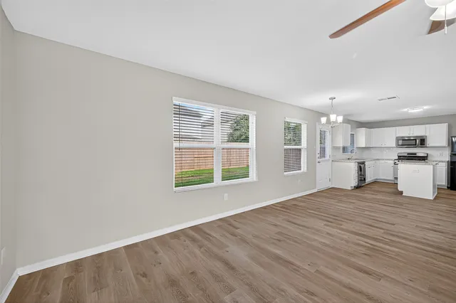 a view of kitchen with wooden floor and windows