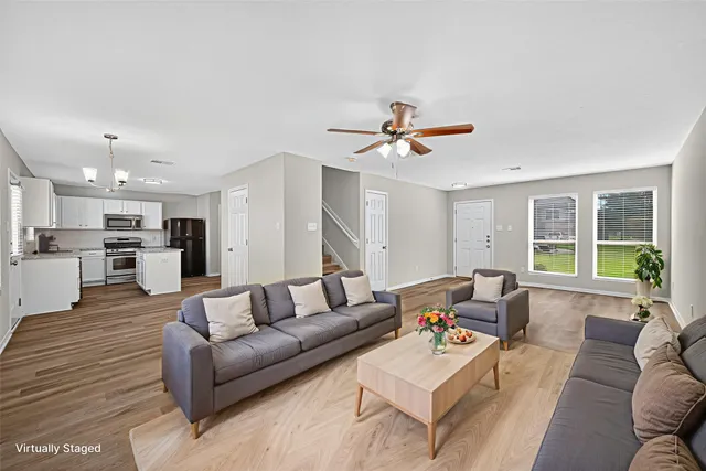 a living room with furniture and kitchen view