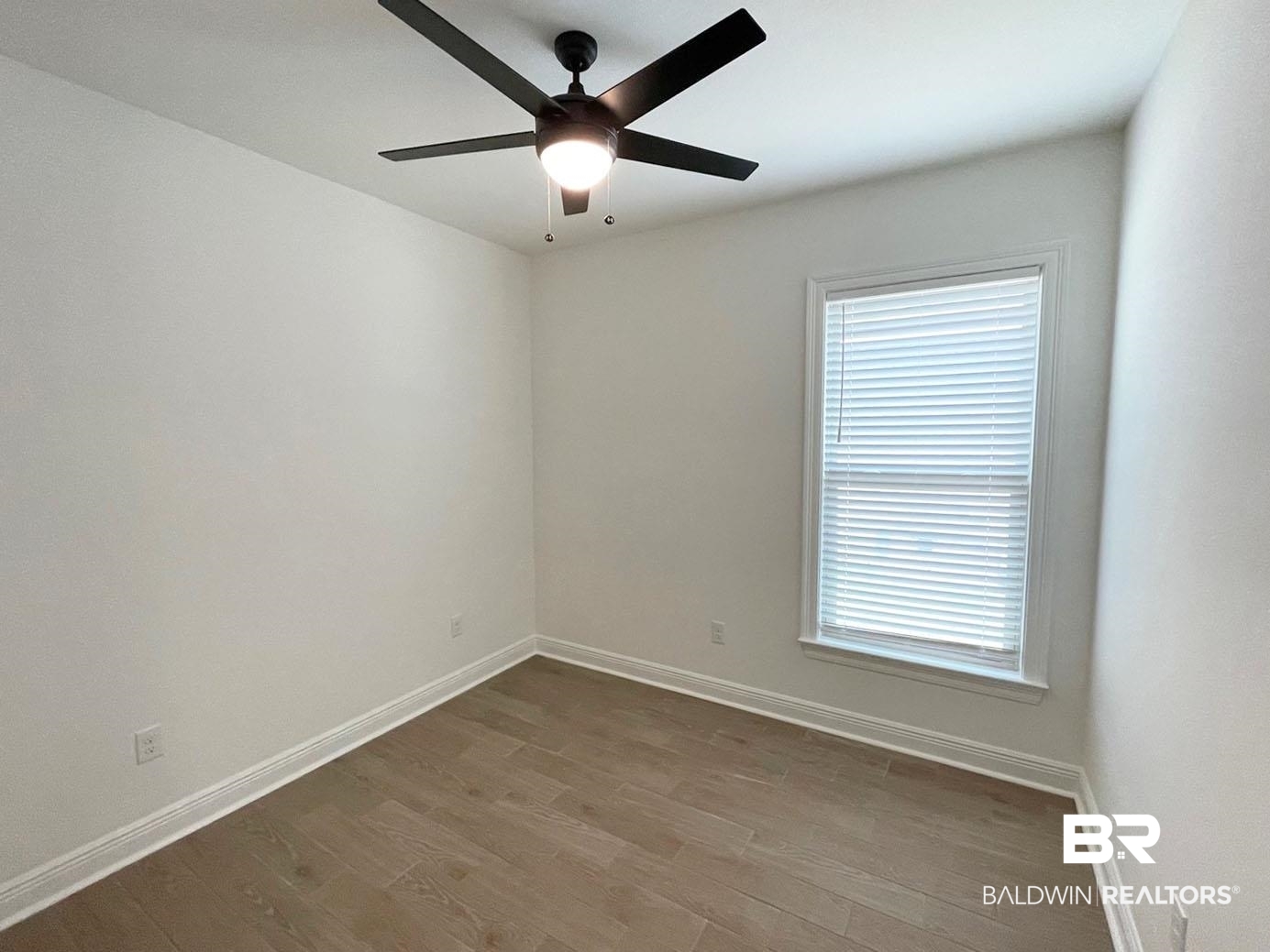 1339 Fenton Circle Foley, AL 36535 - Photo 11 of 17 Empty room featuring baseboards, wood finished floors, ceiling fan, and plenty of natural light