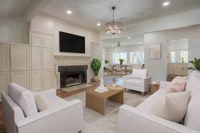 a living room with furniture a flat screen tv and a fireplace