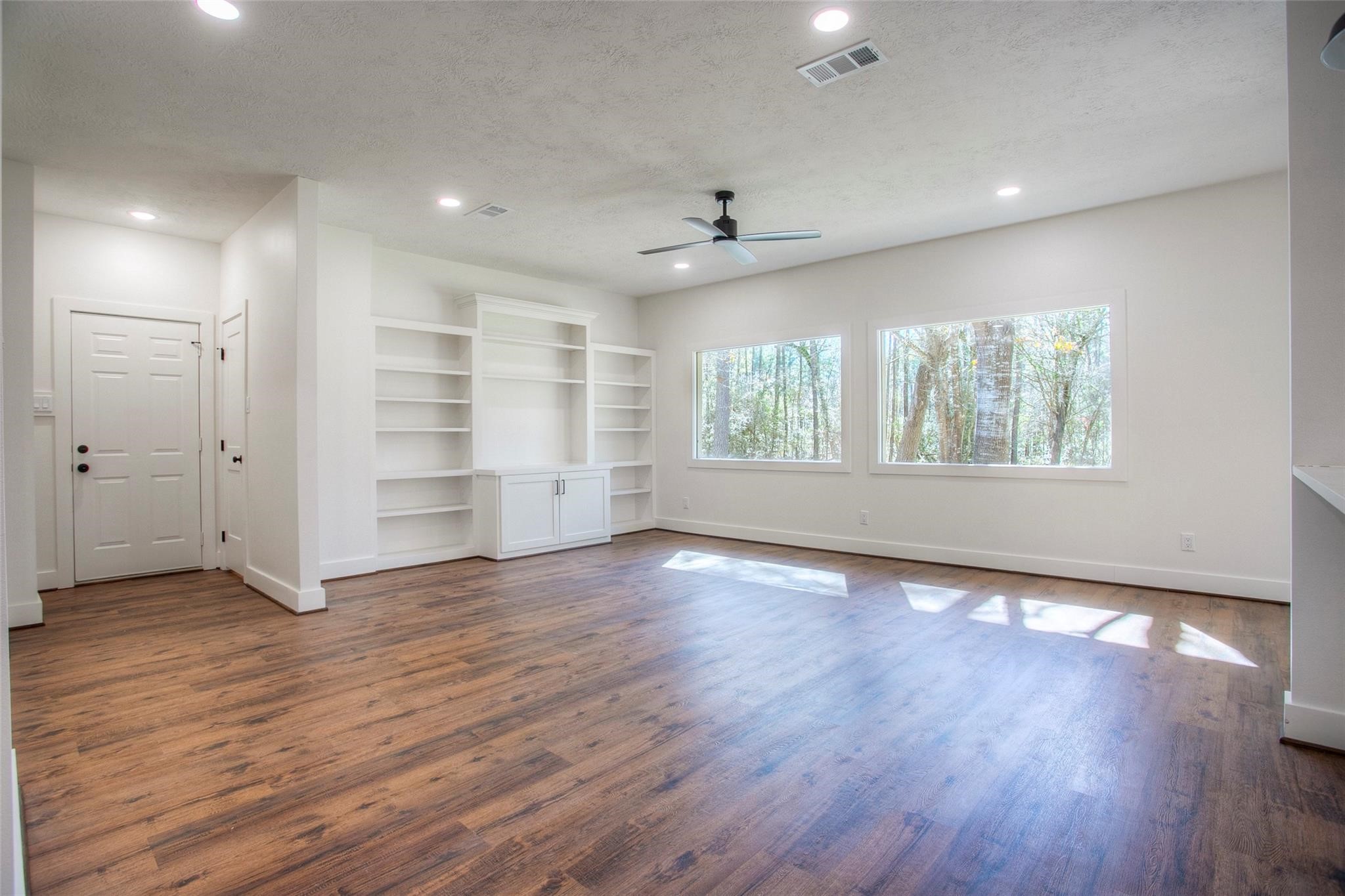 83 Dahlia Road Huntsville, TX 77320 - Photo 13 of 49 a view of an empty room with wooden floor and a window