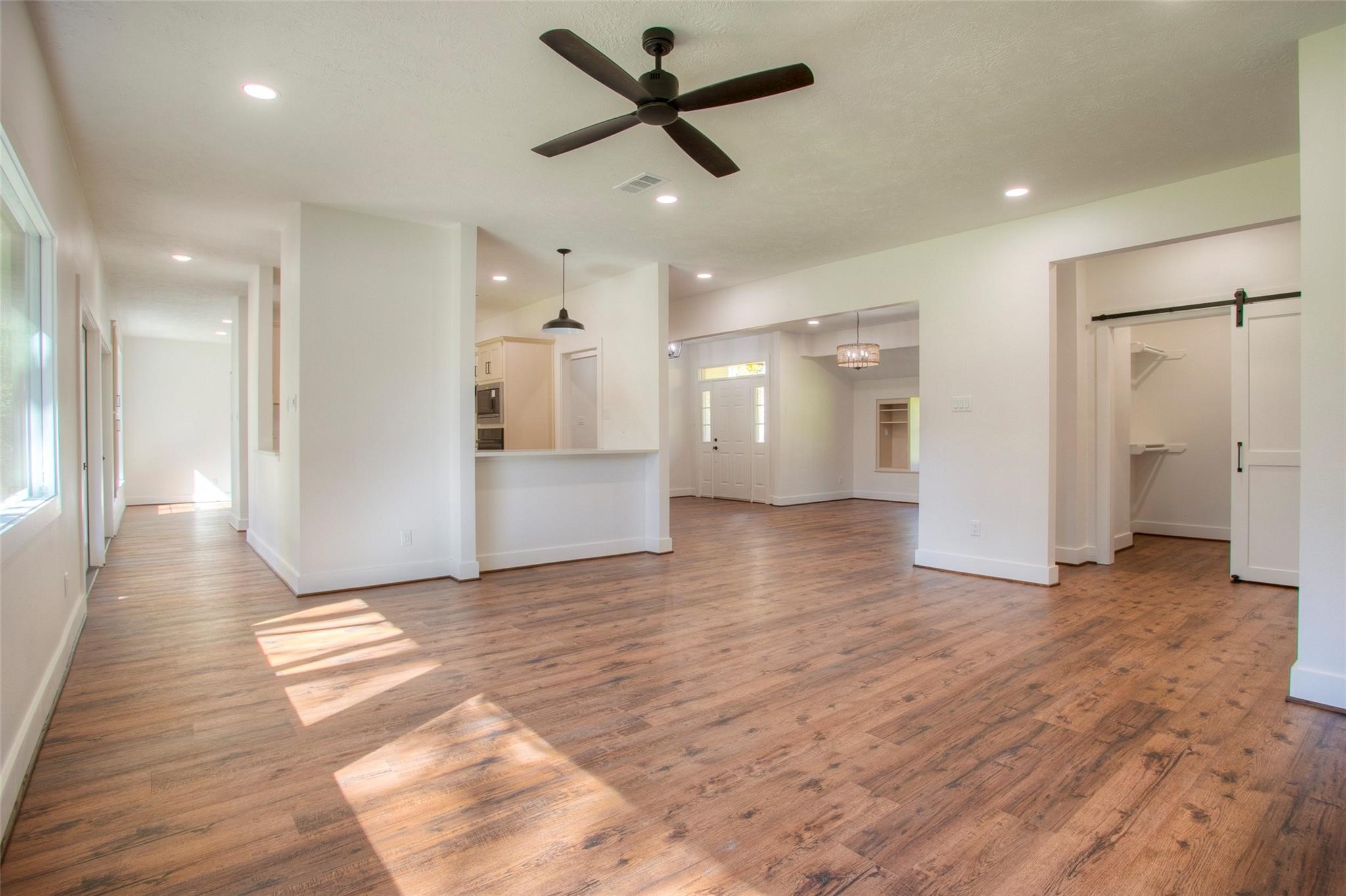 83 Dahlia Road Huntsville, TX 77320 - Photo 14 of 49 a view of a livingroom with a ceiling fan wooden floor and a ceiling fan