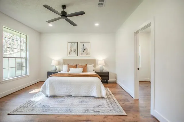 a bedroom with a large bed and a window