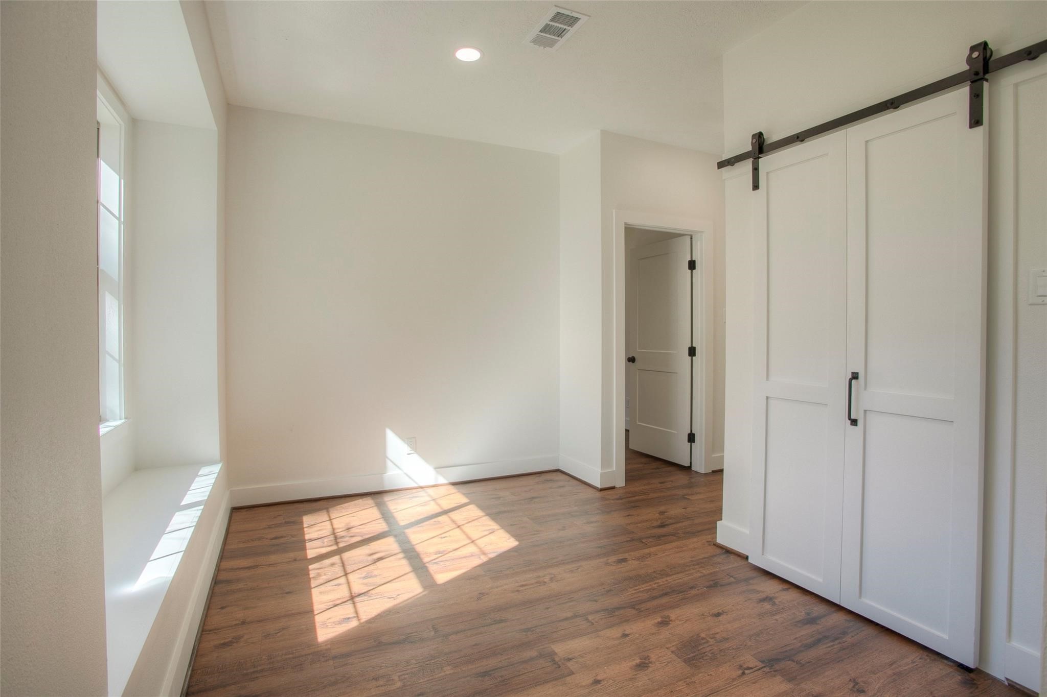 83 Dahlia Road Huntsville, TX 77320 - Photo 21 of 49 a view of empty room with wooden floor and fan