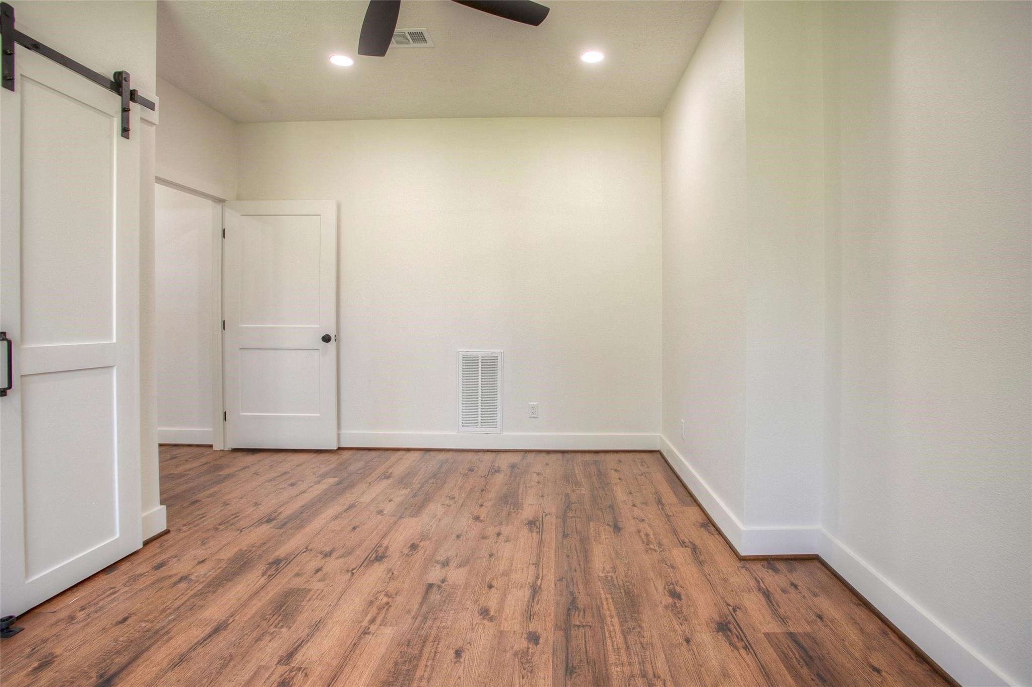 83 Dahlia Road Huntsville, TX 77320 - Photo 28 of 49 a view of an empty room with wooden floor and a window