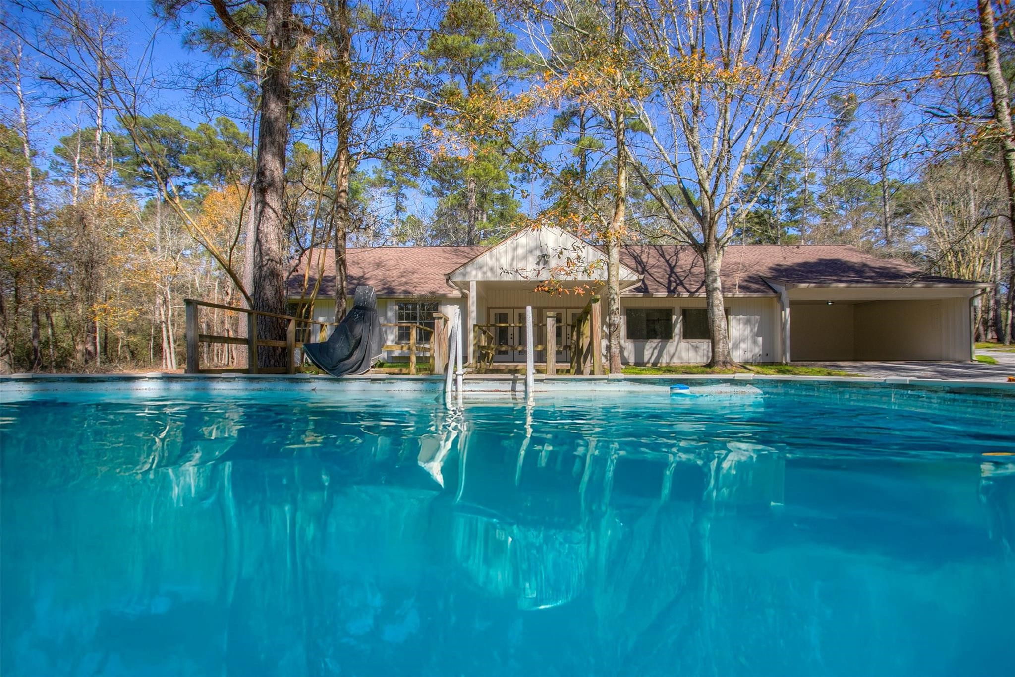 83 Dahlia Road Huntsville, TX 77320 - Photo 42 of 49 a front view of a house with a garden