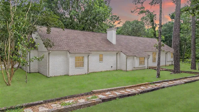 a front view of a house with a garden and yard