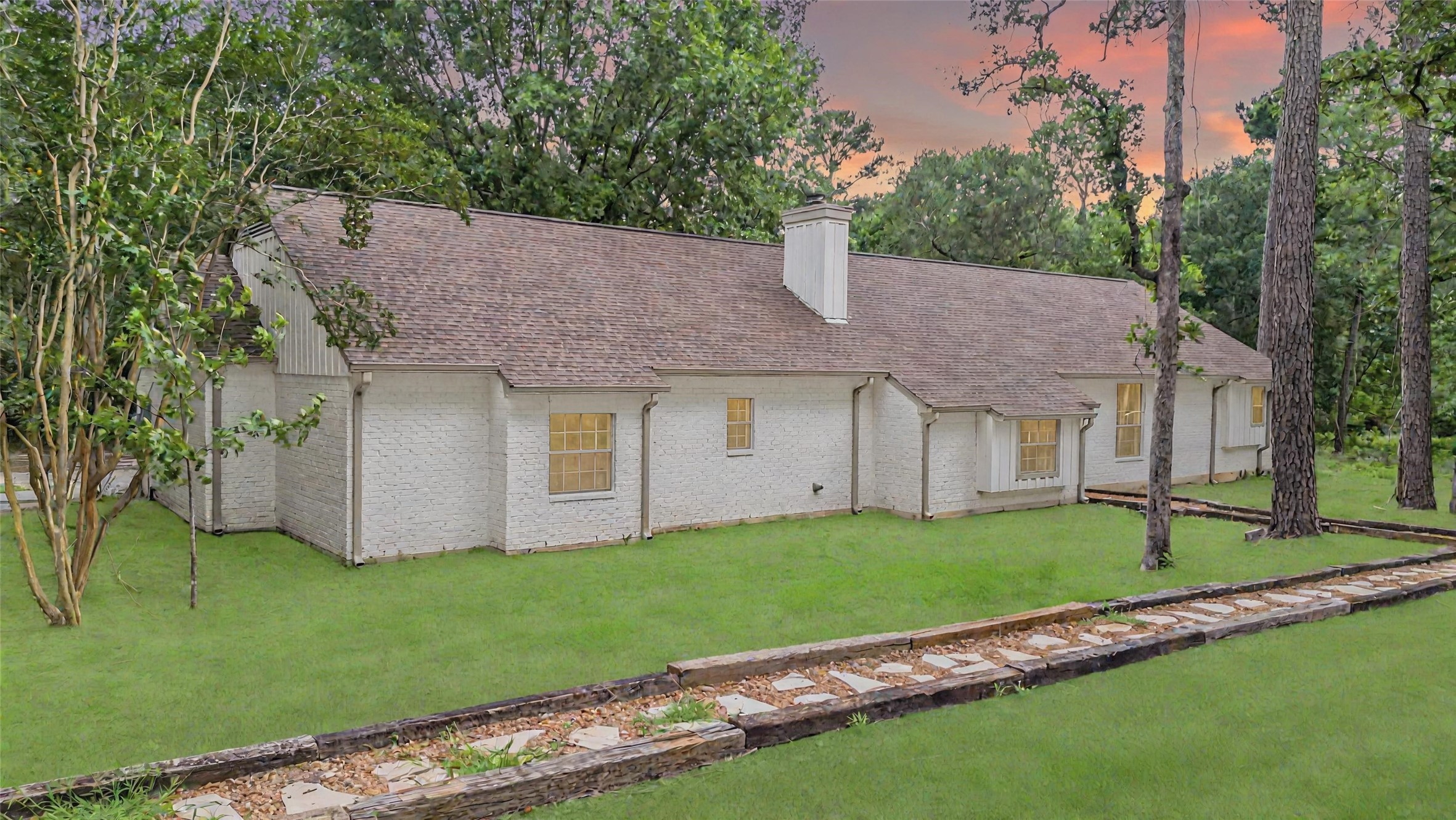 83 Dahlia Road Huntsville, TX 77320 - Photo 6 of 49 a front view of a house with a garden and yard