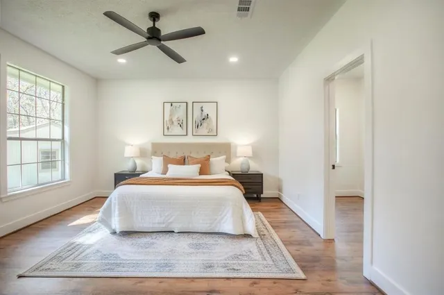 a bedroom with a large bed and a window