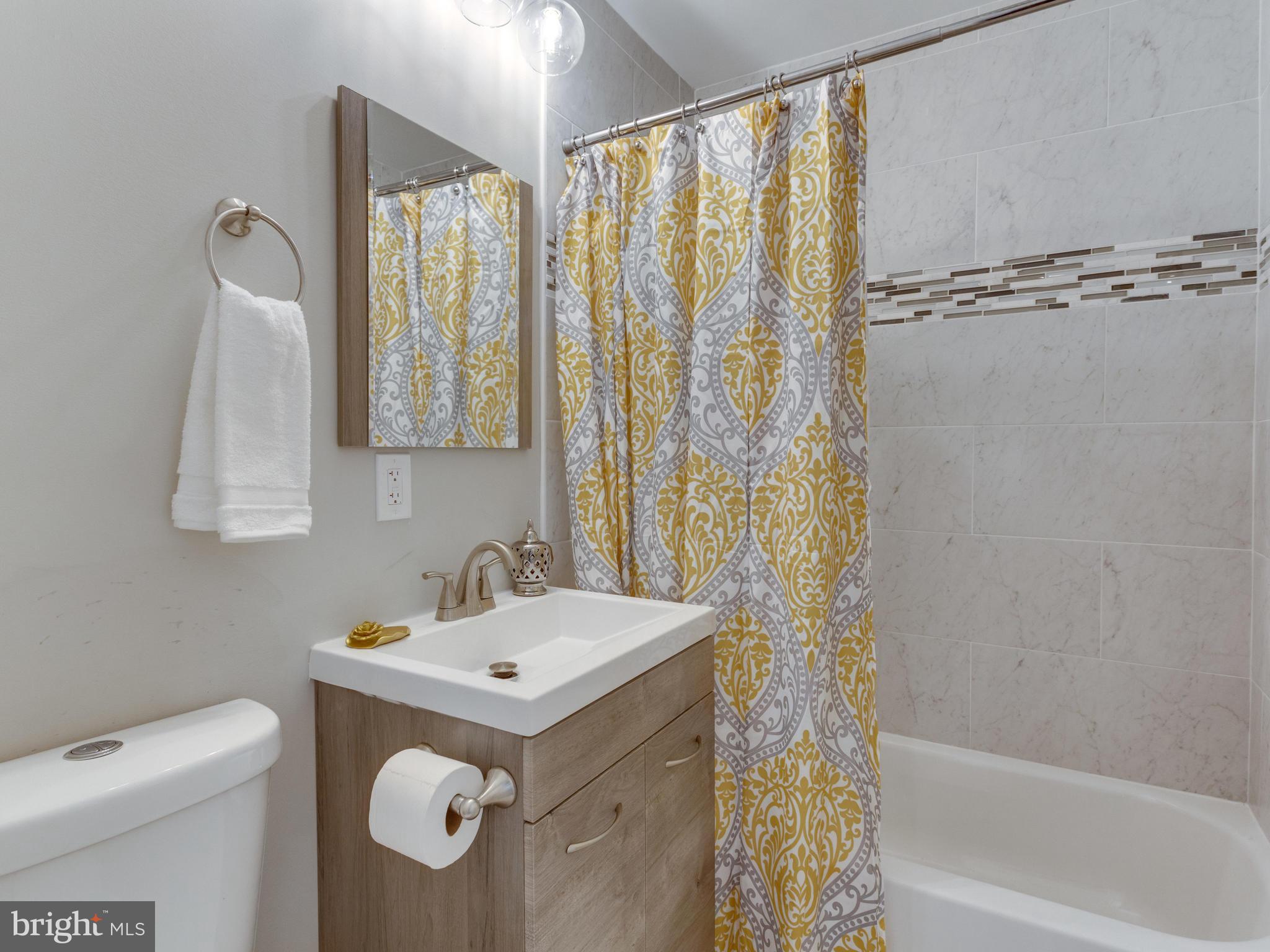 1819 Anderson Road Falls Church, VA 22043 - Photo 13 of 21 a bathroom with a sink a toilet and a shower curtain