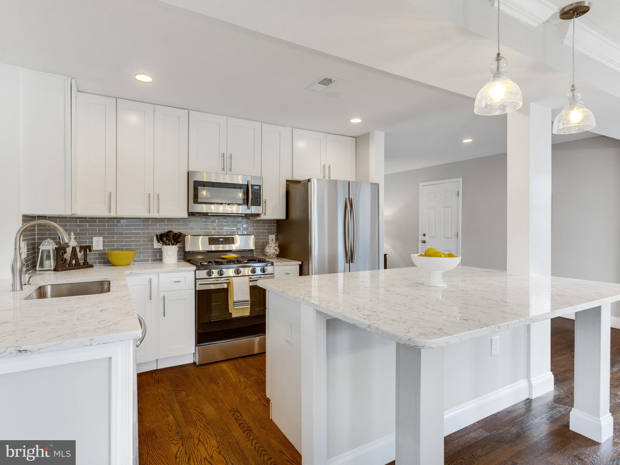 1819 Anderson Road Falls Church, VA 22043 - Photo 5 of 21 a kitchen with stainless steel appliances a stove a sink a refrigerator a center island and cabinets
