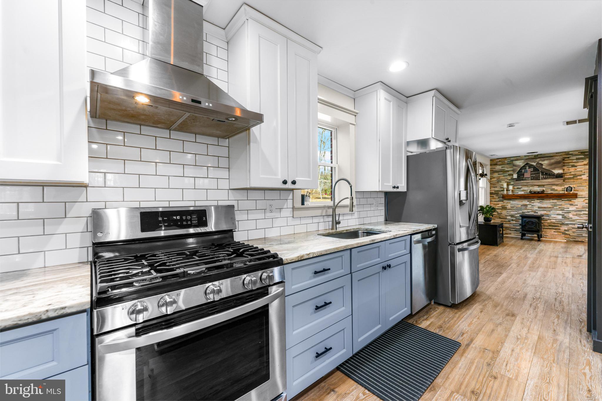 6204 Ebenezer Road Middle River, MD 21220 - Photo 19 of 70 a kitchen with wooden cabinets and a stove top oven