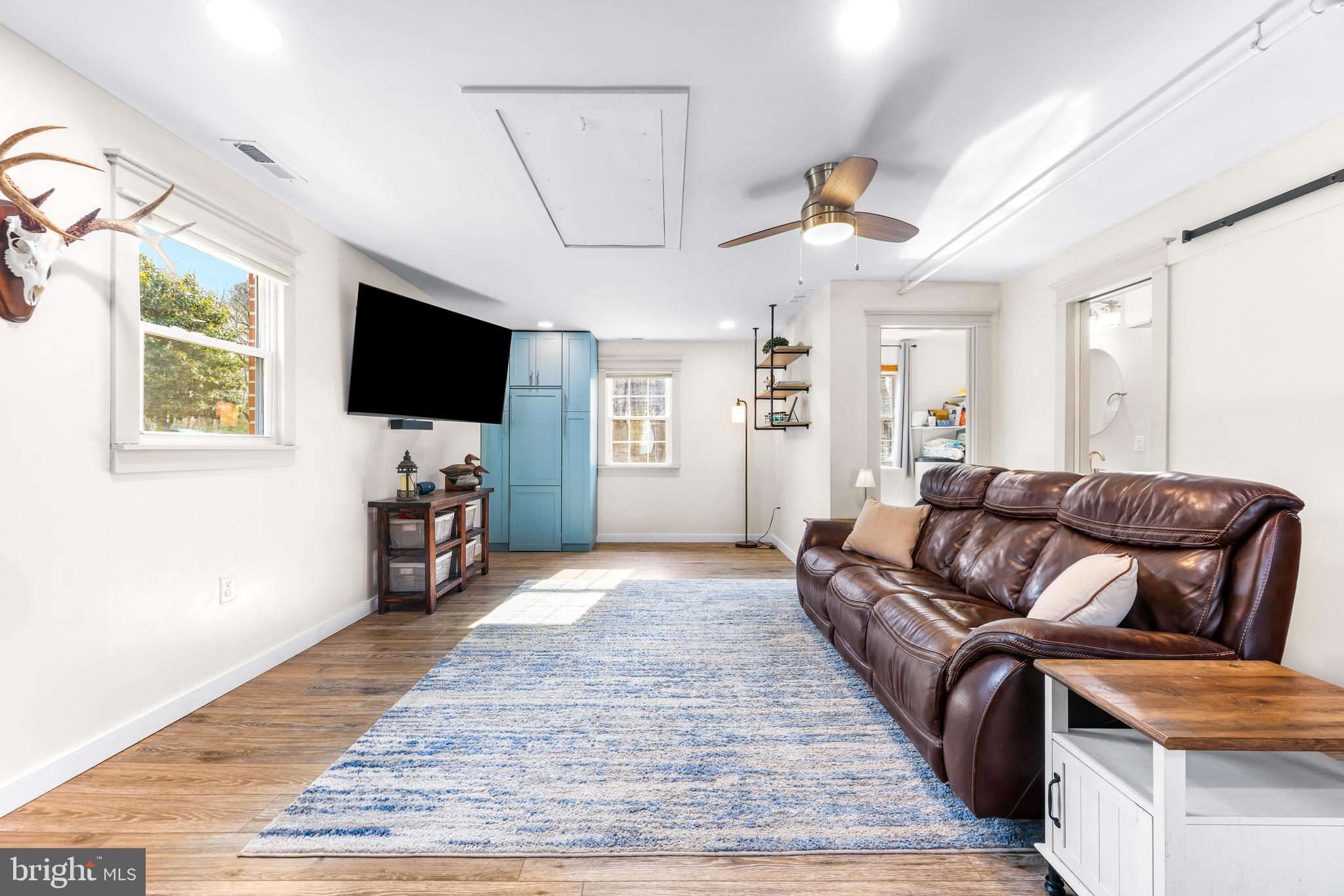 6204 Ebenezer Road Middle River, MD 21220 - Photo 23 of 70 a living room with furniture and a flat screen tv