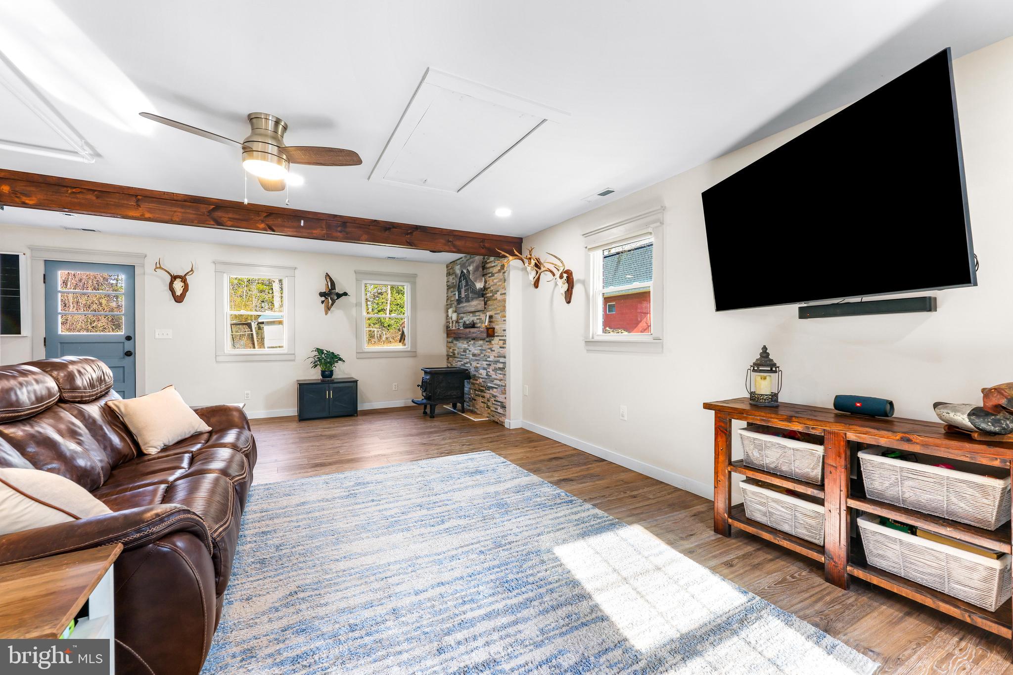 6204 Ebenezer Road Middle River, MD 21220 - Photo 25 of 70 a living room with furniture and a flat screen tv