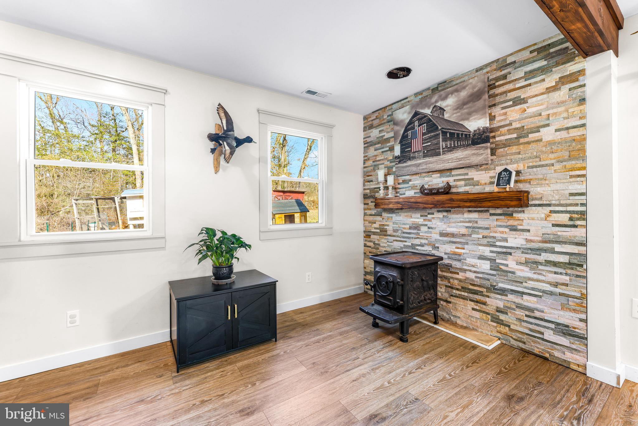 6204 Ebenezer Road Middle River, MD 21220 - Photo 26 of 70 a living room with furniture wooden floor and a fireplace