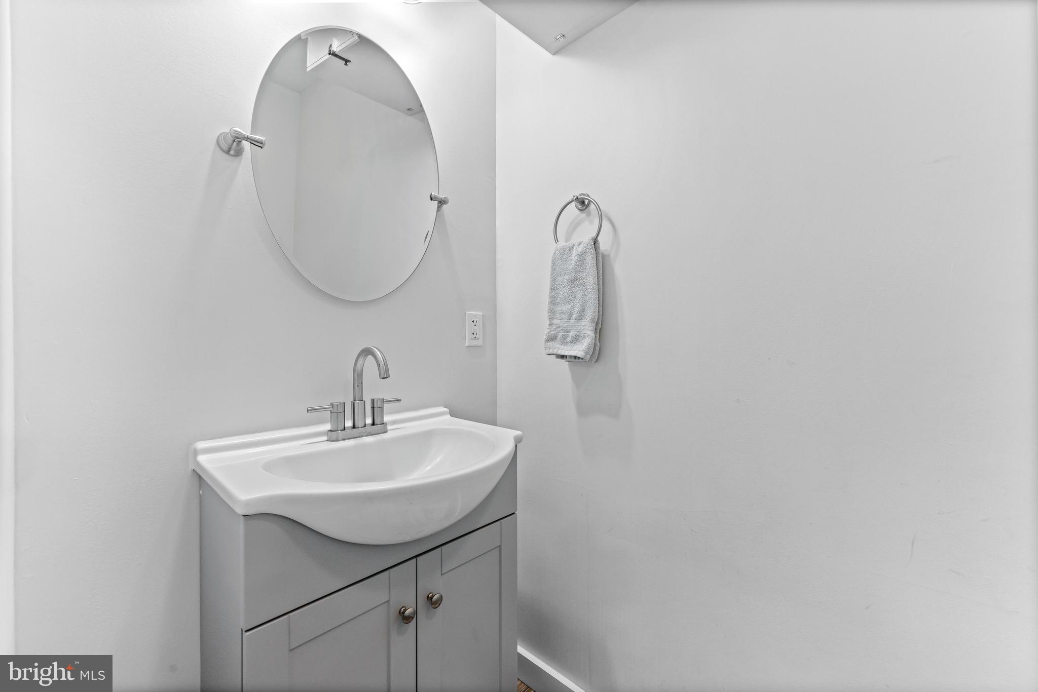 6204 Ebenezer Road Middle River, MD 21220 - Photo 29 of 70 a bathroom with a sink and a mirror