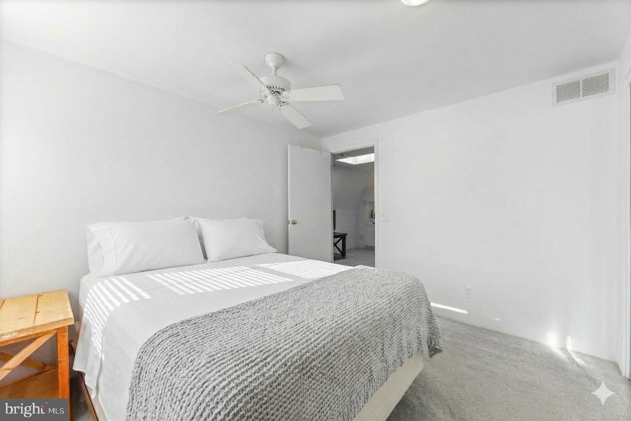 6204 Ebenezer Road Middle River, MD 21220 - Photo 52 of 70 a bedroom with a bed and a chandelier