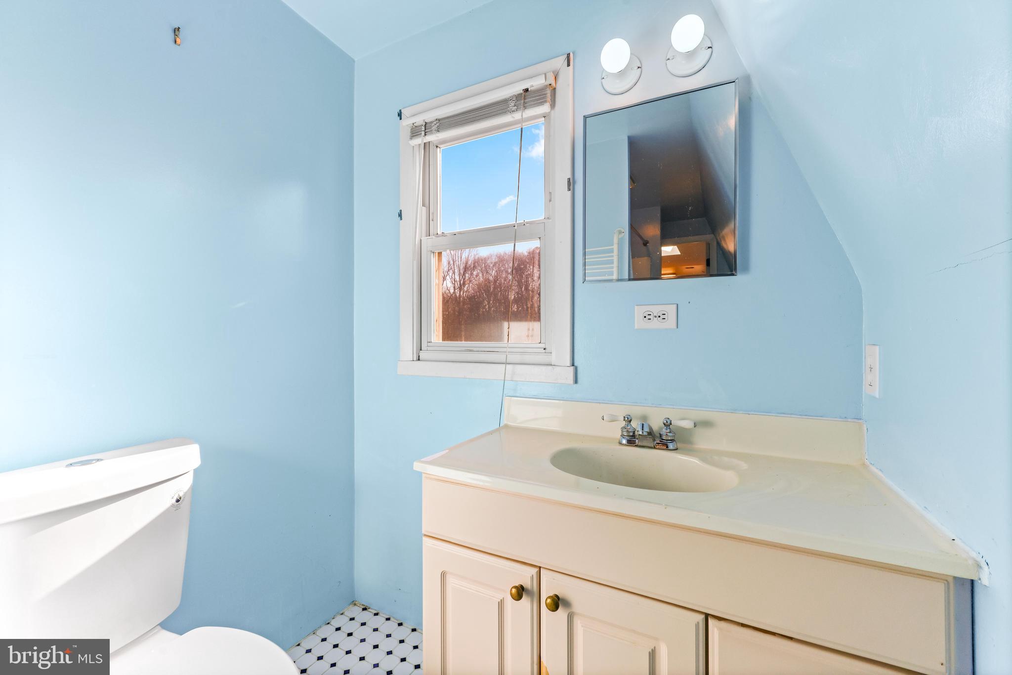 6204 Ebenezer Road Middle River, MD 21220 - Photo 55 of 70 a bathroom with a sink toilet and a mirror