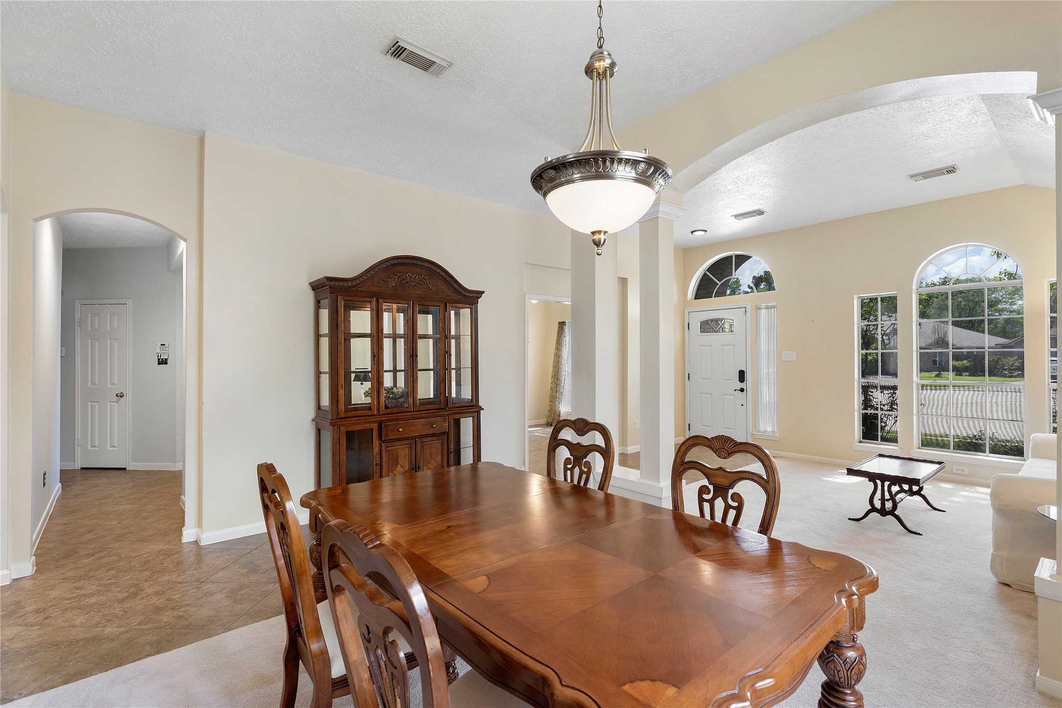 1707 Moston Drive Spring, TX 77386 - Photo 7 of 41 a dining room with furniture a chandelier and wooden floor