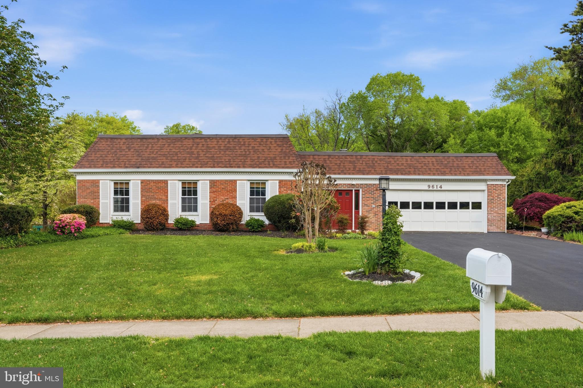 9614 Percussion Way Vienna, VA 22182 - Photo 1 of 45 a front view of a house with a garden