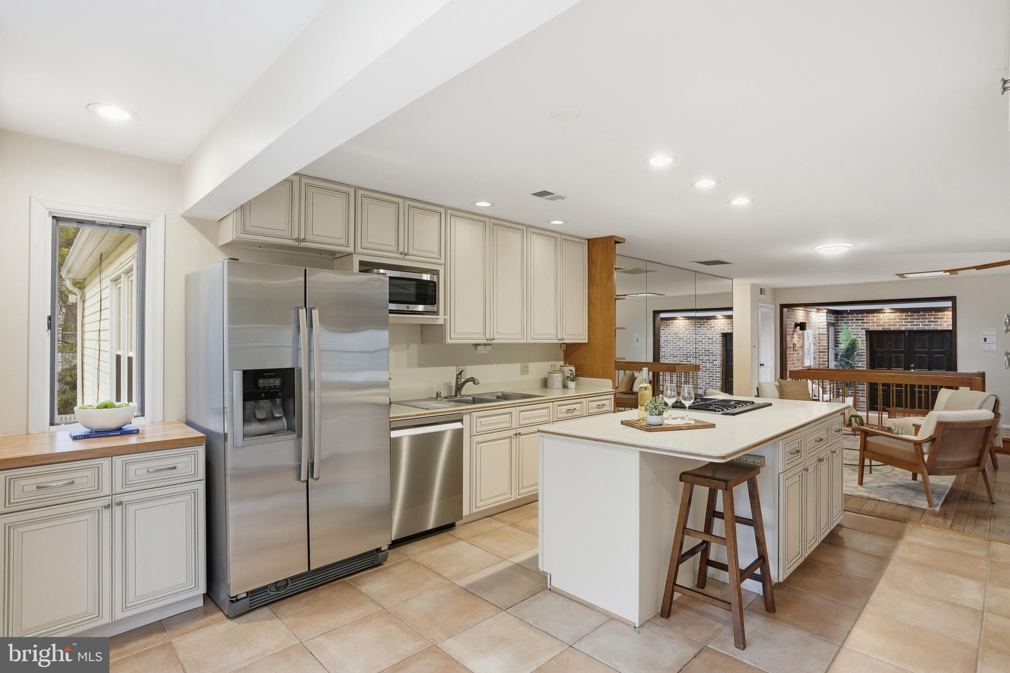 9614 Percussion Way Vienna, VA 22182 - Photo 16 of 45 a kitchen that has a lot of white cabinets and stainless steel appliances