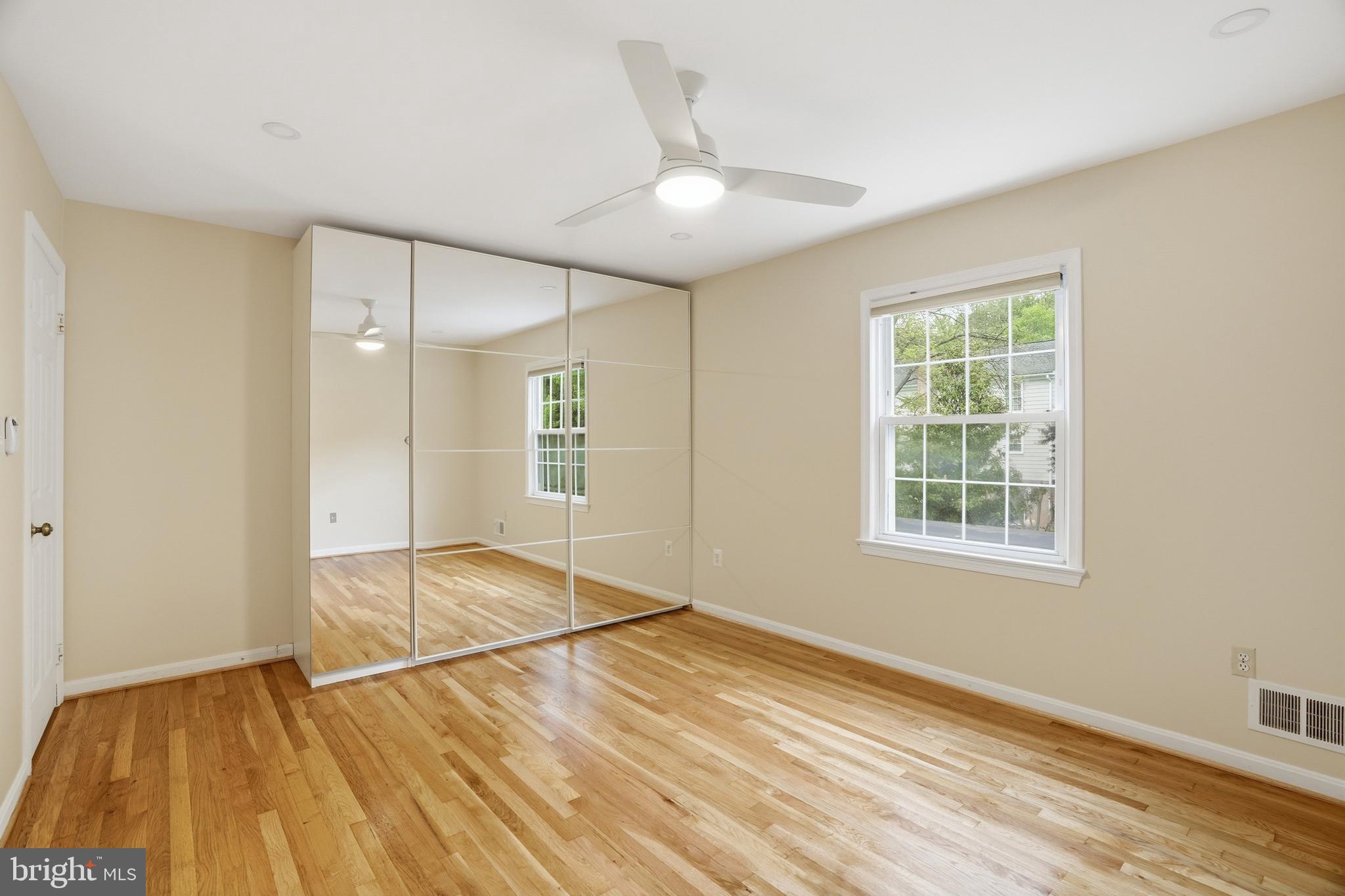 9614 Percussion Way Vienna, VA 22182 - Photo 25 of 45 a view of an empty room with wooden floor and a window