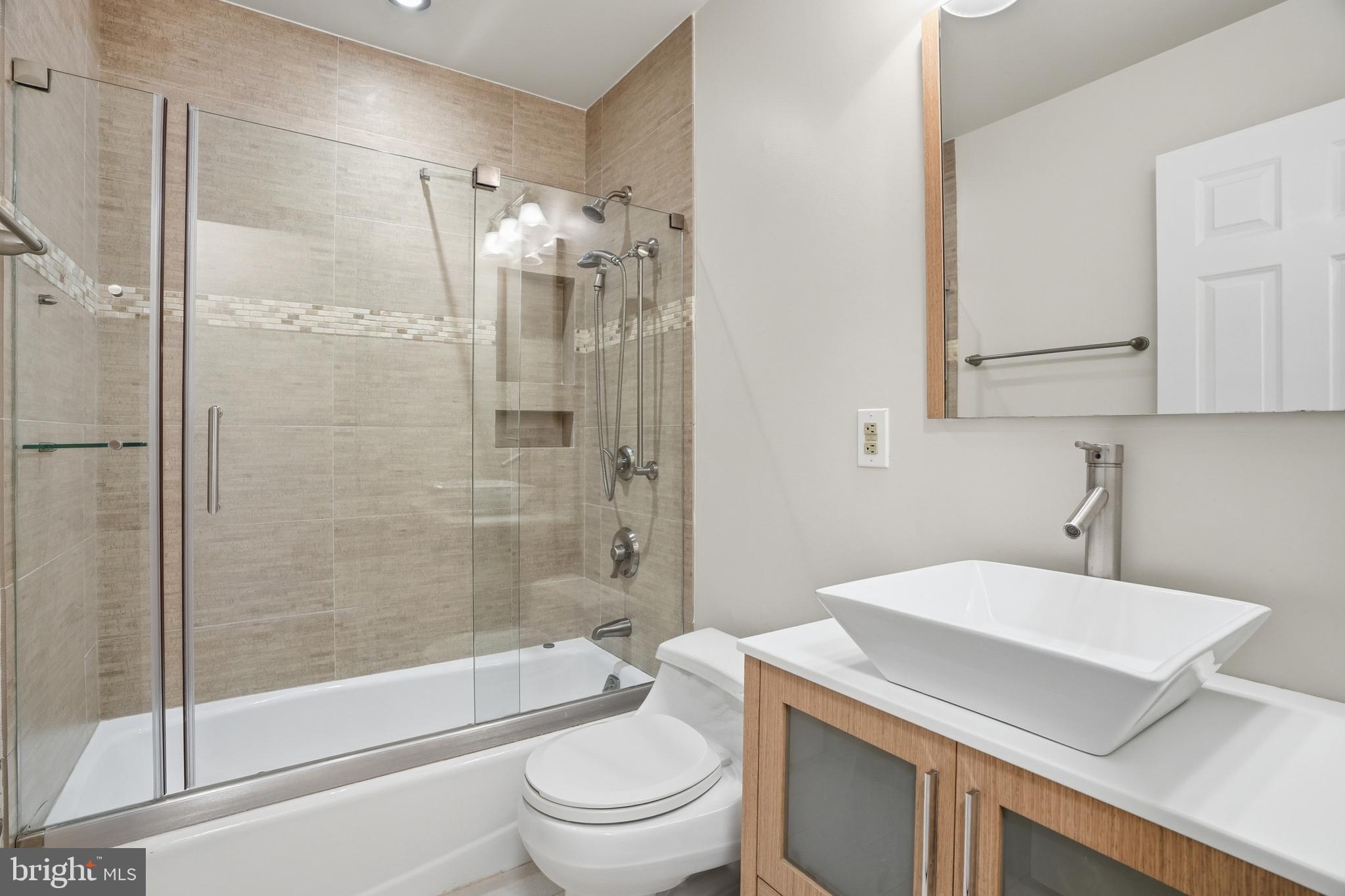 9614 Percussion Way Vienna, VA 22182 - Photo 27 of 45 a bathroom with a sink toilet and shower