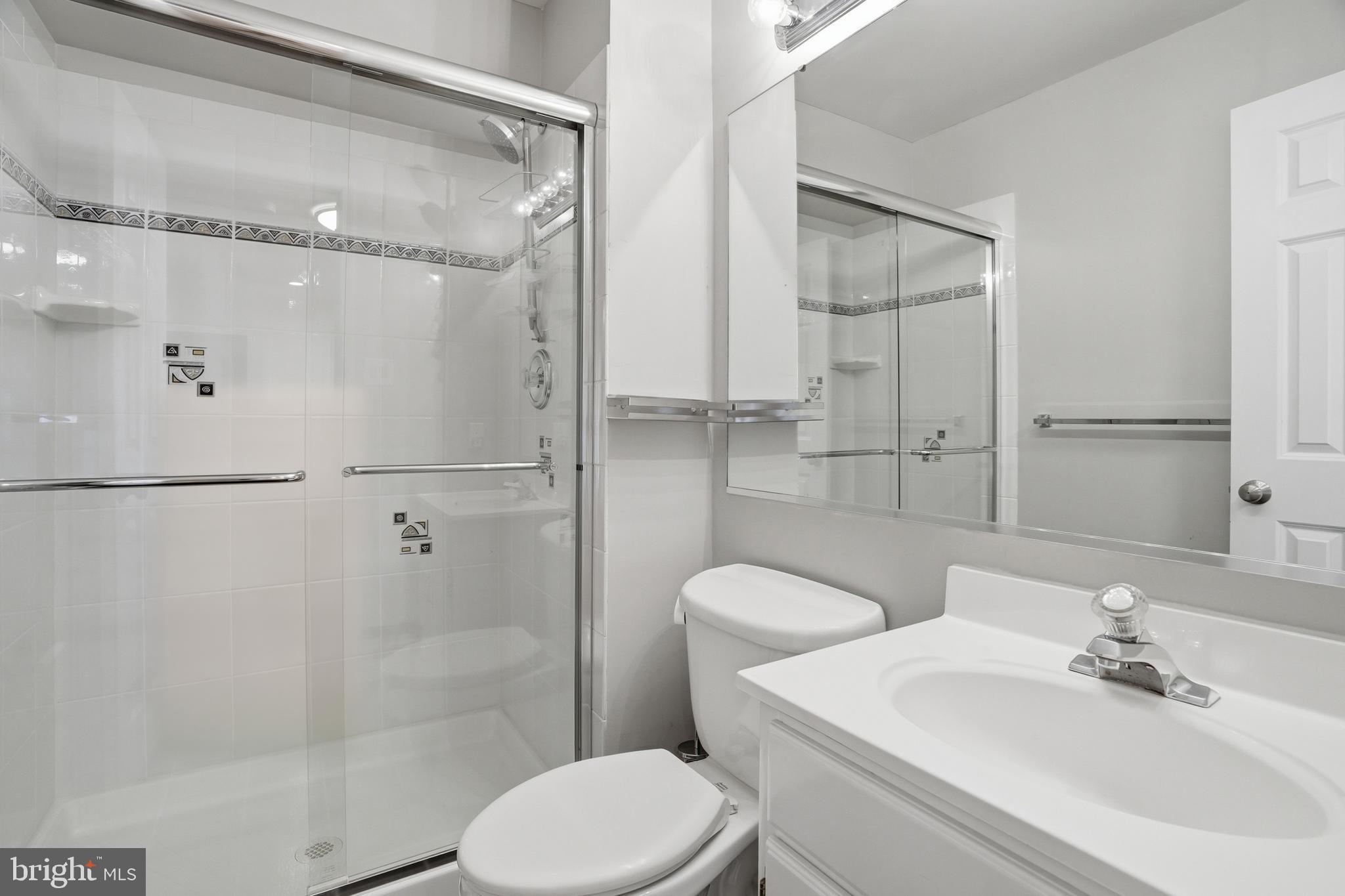 9614 Percussion Way Vienna, VA 22182 - Photo 30 of 45 a bathroom with a sink toilet and shower