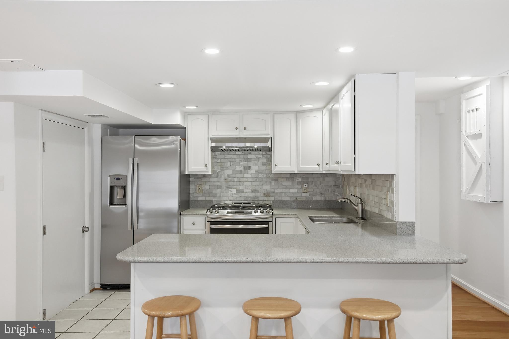 9614 Percussion Way Vienna, VA 22182 - Photo 31 of 45 a kitchen with stainless steel appliances granite countertop a sink a refrigerator and a stove