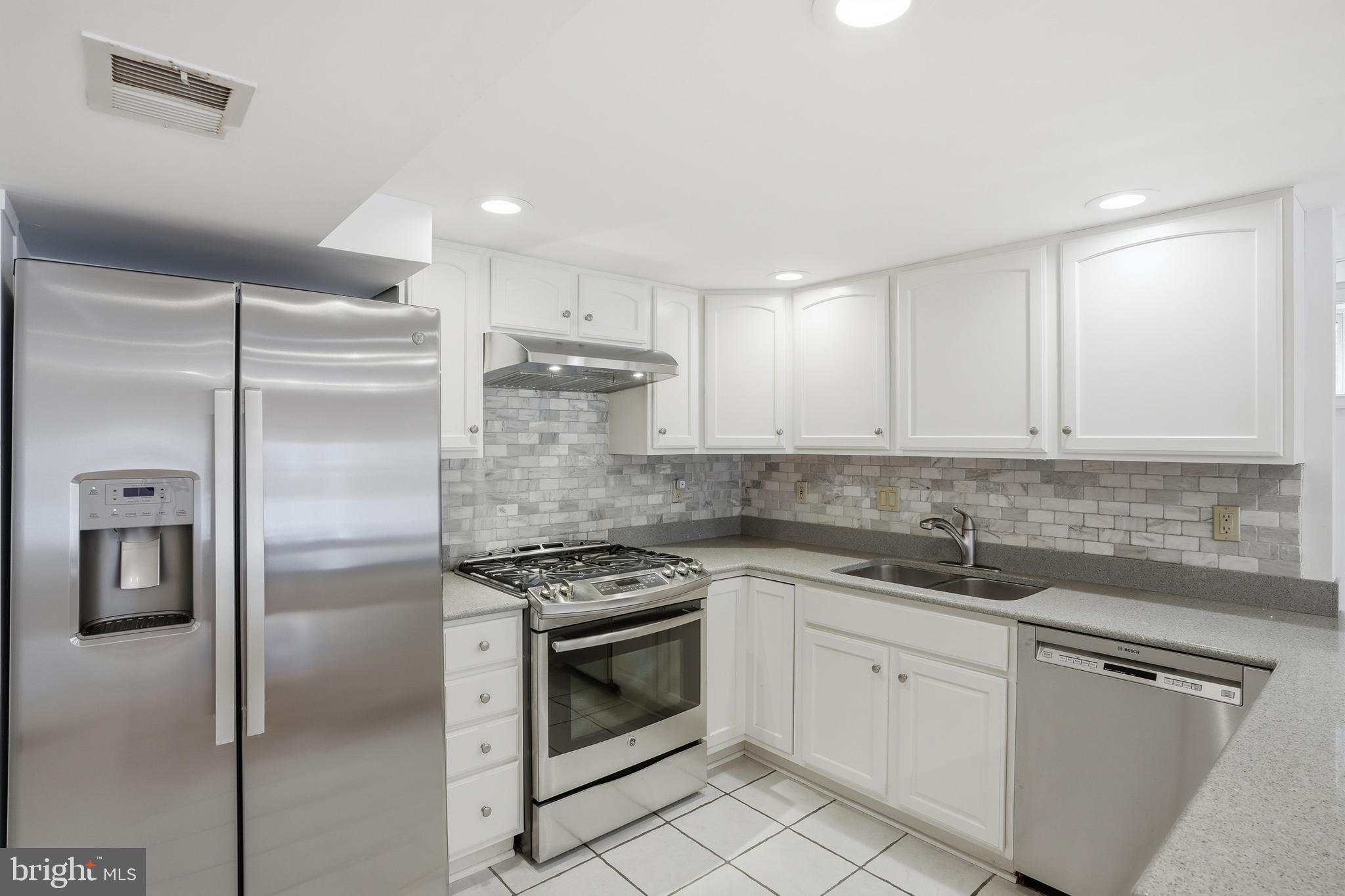 9614 Percussion Way Vienna, VA 22182 - Photo 32 of 45 a kitchen with a refrigerator sink and cabinets