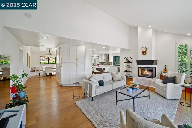a living room with fireplace furniture and a wooden floor