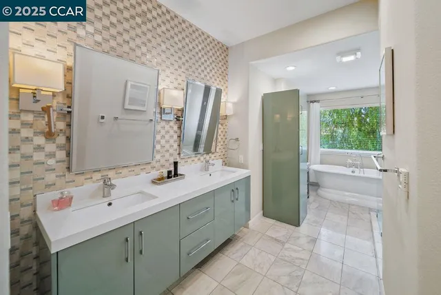 a bathroom with a double vanity sink a toilet and a mirror