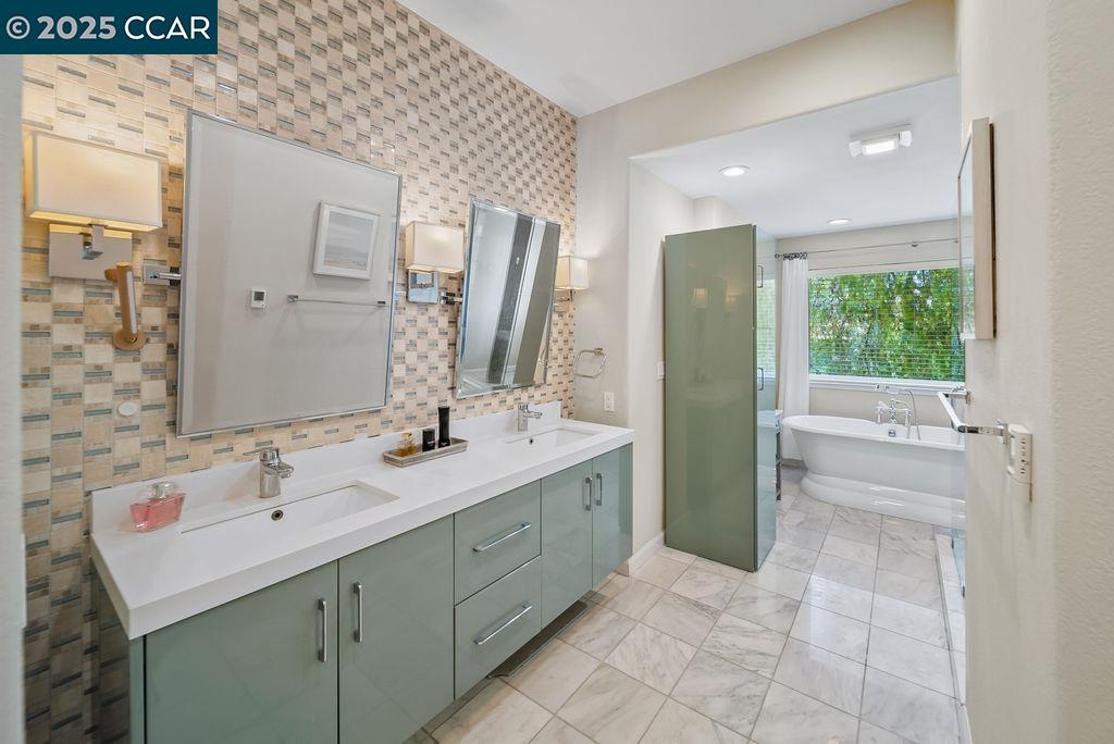 172 Rudgear Drive Walnut Creek, CA 94596 - Photo 30 of 51 a bathroom with a double vanity sink a toilet and a mirror