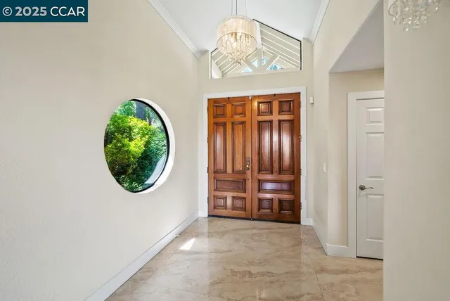 an empty room with a window and a mirror