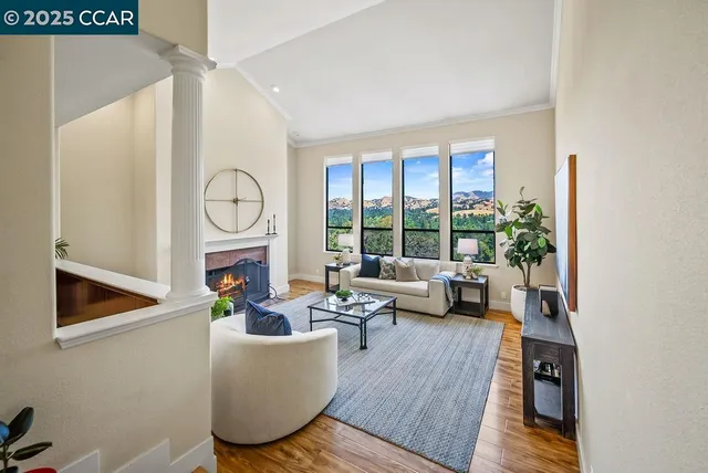 a living room with furniture and a floor to ceiling window