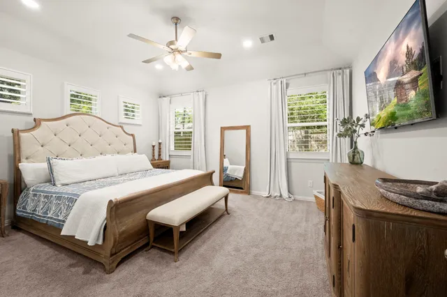 a spacious bedroom with a bed and window