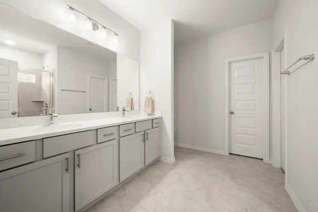 a bathroom with 2 sink and a mirror